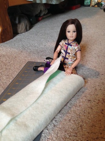 Here, Ping Lei wraps batting around the foam.