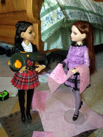 And here, Prudence and Lizette work at cutting the fabric to the specific measurements.